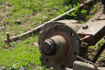 An old car hub embedded in the ground