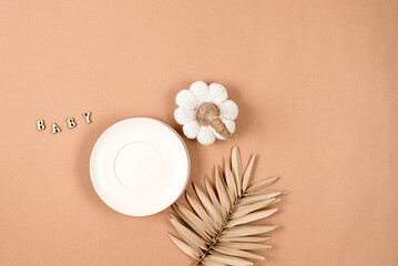 Flat lay composition with silicone baby beige dishware on pastel beige color background. Minimal...