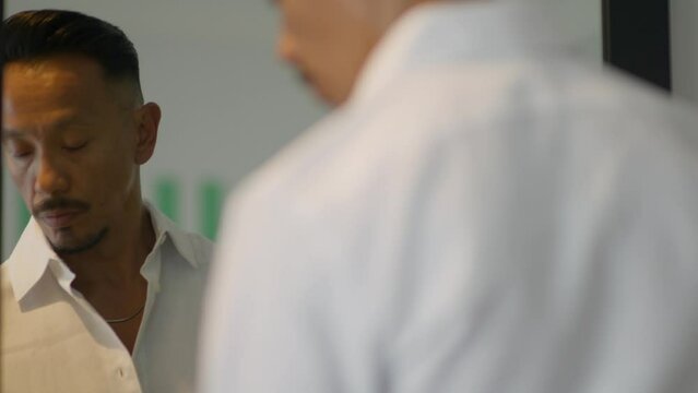 Man Putting On Cologne In Front Of Mirror, Close Up 85mm