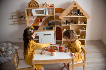 girls play tea drinking at the table