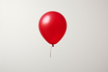 Standout red balloon on a clean white backdrop, emphasizing simplicity and contrast.