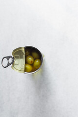 Green olives in a metal tin, pitted pepper stuffed canned green olives