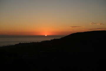 bright sunset over the mountains and ocean