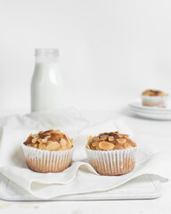 vanilla almond muffins on a white napkin, homemade bakery style almond muffins on a white background