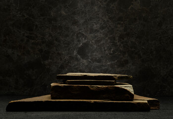 stone podium. brown natural stones for product presentation on a dark background