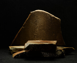 stone podium. brown natural stones for product presentation on a dark background