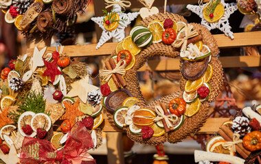 Round wreaths made of dried fruits and vegetables. Christmas decorations for holiday. © Yasonya