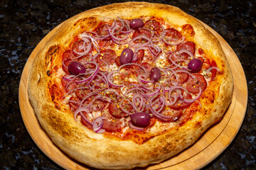 Traditional Calabrian sausage pizza with red onion and black olives