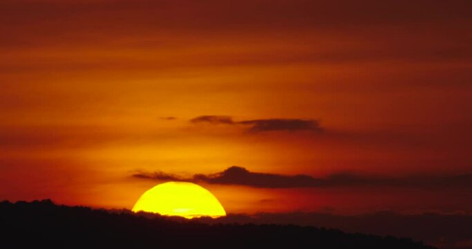 Big Sunrise Timelapse video Close-up the sun in red cloud sky over horizontal.ProRes422