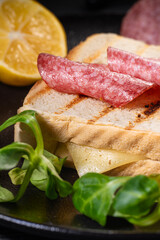 Sandwich with salami, herb cheese and lemon.