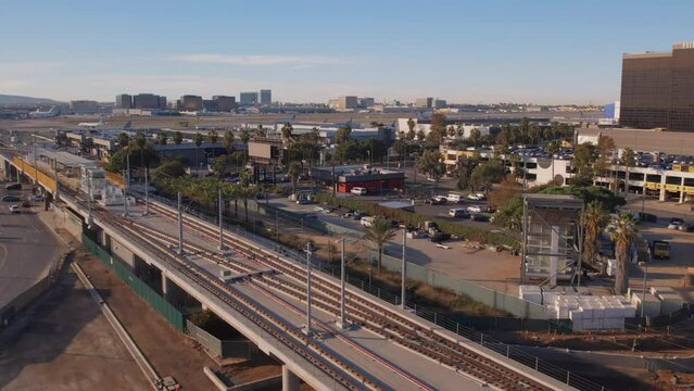 Aerial view of LAX south runway and transit line at sunrise