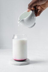 pouring milk into can shaped glass, skimmed milk in a glass shaped like a can, Aesthetic drink in a...
