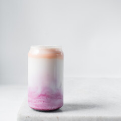 Peach and blueberry yogurt in a can shaped glass, peach blueberry yogurt in a glass shaped like a...