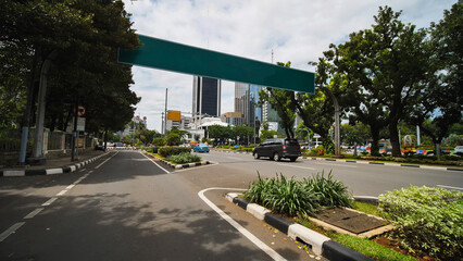 Jakarta's roads and streets with cars during the daytime.