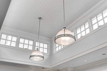 Industrial Steel Hanging Pendant Lights Providing Illumination in Chef Kitchen Interior, Panoramic...