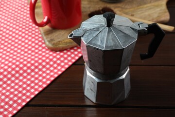 One moka pot on wooden table, closeup