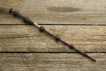 One old magic wand on wooden table, top view
