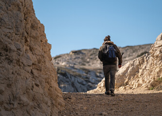 hiker in the mountains on sunny cloudless day