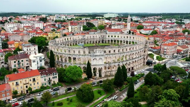 Flying above historic city of Pula , historic Roman amphitheatre of Pula aerial view, tourism in Croatia