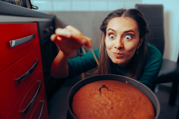 Woman Cooking Using a Toothpick Checking on her Baked Cake. Experienced cook trying to see if the...