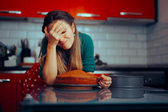 Unhappy Woman Making an Uneven Baked Birthday Sponge Cake. Exasperated housewife making mistake while baking a cake
