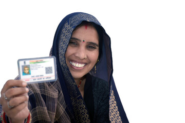 Indian rural woman wearing a sari with smiling face shows her blurred aadhar card in her hand, isolated white background