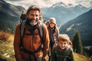 A happy family with backpacks smiles on a mountain hike, with stunning alpine scenery in the background. - obrazy, fototapety, plakaty