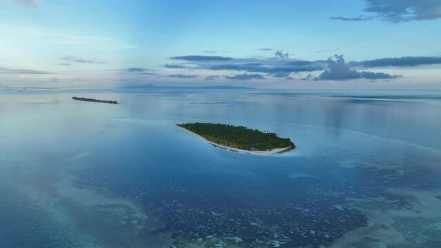 Early morning light illuminates the remote island of Koon near Seram, Indonesia. This scenic island's coral reefs, and the surrounding seas, support extraordinary marine biodiversity.