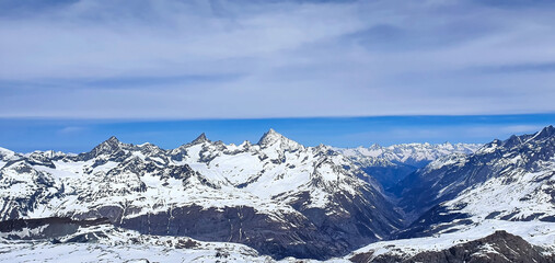 Fototapeta na wymiar The banner mountain view of alpine as snow-capped mount peaks scene in Winter mountains background