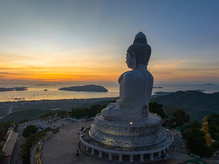 .aerial view scenery yellow sky glare of sun above Phuket big Buddha.Phuket Big Buddha is one of the island most important and revered landmarks on the island..image for travel and culture concept. © Narong Niemhom