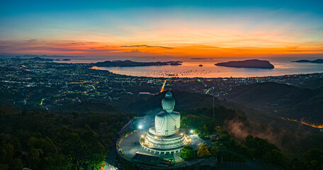 Aerial view scenery yellow light at horizon at sunrise in front of Phuket Big Buddha.the golden sun...