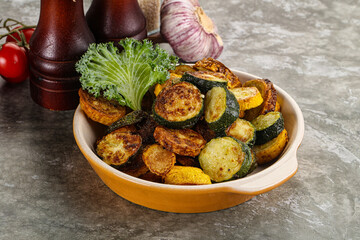 Roasted young zucchini in the plate