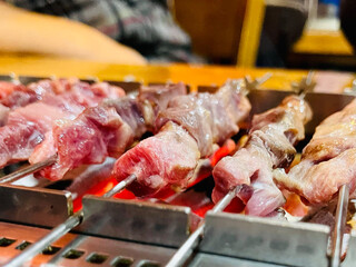 Lamb skewers grilled on a brazier