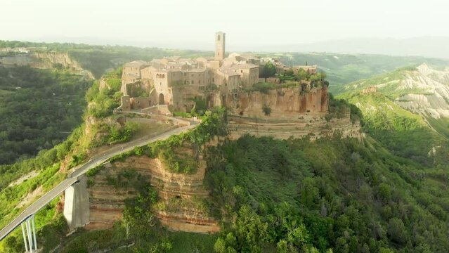 Aerial summer evening view of famous Civita di Bagnoregio town, beautiful place located on top of a volcanic tuff hill overlooking the Tiber river valley. The place has Etruscan and Medieval origins.