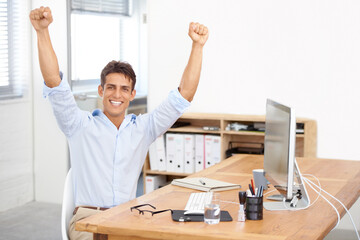 Happy businessman, portrait and fist pump in celebration for winning, success or bonus promotion at office. Excited man or employee smile by desk for prize, deal or good news on computer at workplace