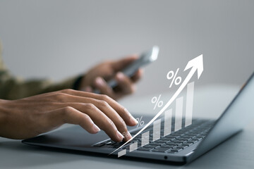 Interest rate and dividend concept, Businessman using laptop to analyzing the economic growth graph...