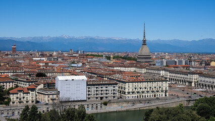 Cityscape of Turin, Italy, featuring the iconic Mole Antonelliana building that stands out among...
