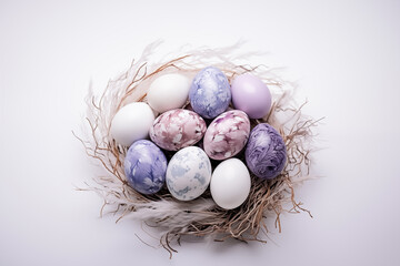 Obraz premium Colorized Easter eggs in a bird's nest on a white background.