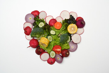 Heart made of various raw vegetables. Flat lay, top view and healthy food concept.