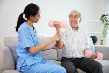 nurse or caregiver helping elderly patient to physiotherapist and exercise for rehabilitation at...