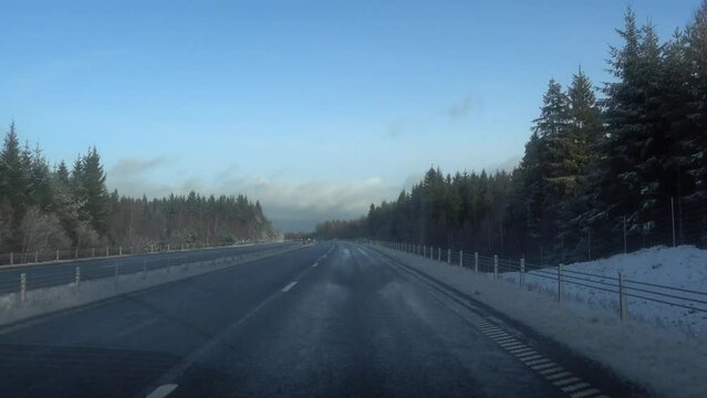 Helsingborg, Sweden A car drives along a snowy E4 highway in the winter. 