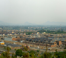 New residential area construction site at suburban with ecological and sustainable green buildings