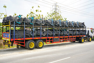 Trailer truck that transports many new motorbikes coming from the motorbike factory to be delivered...