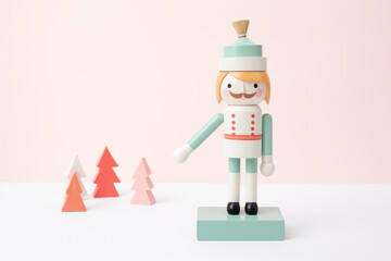 toy nutcracker on pink pastel