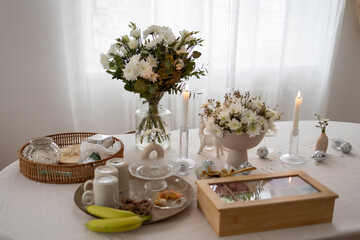 Flowers, tea box and decoration on a table