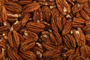 Top view of shelled pecans layered as a background