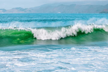 Wave splashing close-up. Crystal clear sea water, in the ocean in San Francisco Bay, blue water, pastel colors.