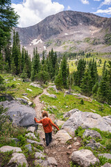 Girl hiking down a trail in the Holy Cross Wilderness, Colorado