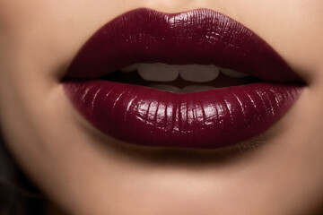 Close-up of beautiful lips with bordeaux lipstick