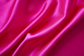 Pink silk or satin background, wavy, elegant and elegant. Close-up, background. Space for designblur or blurry